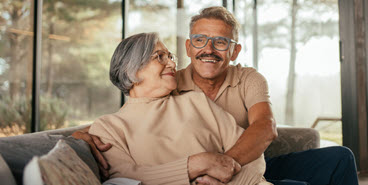 Couple hugging on couch