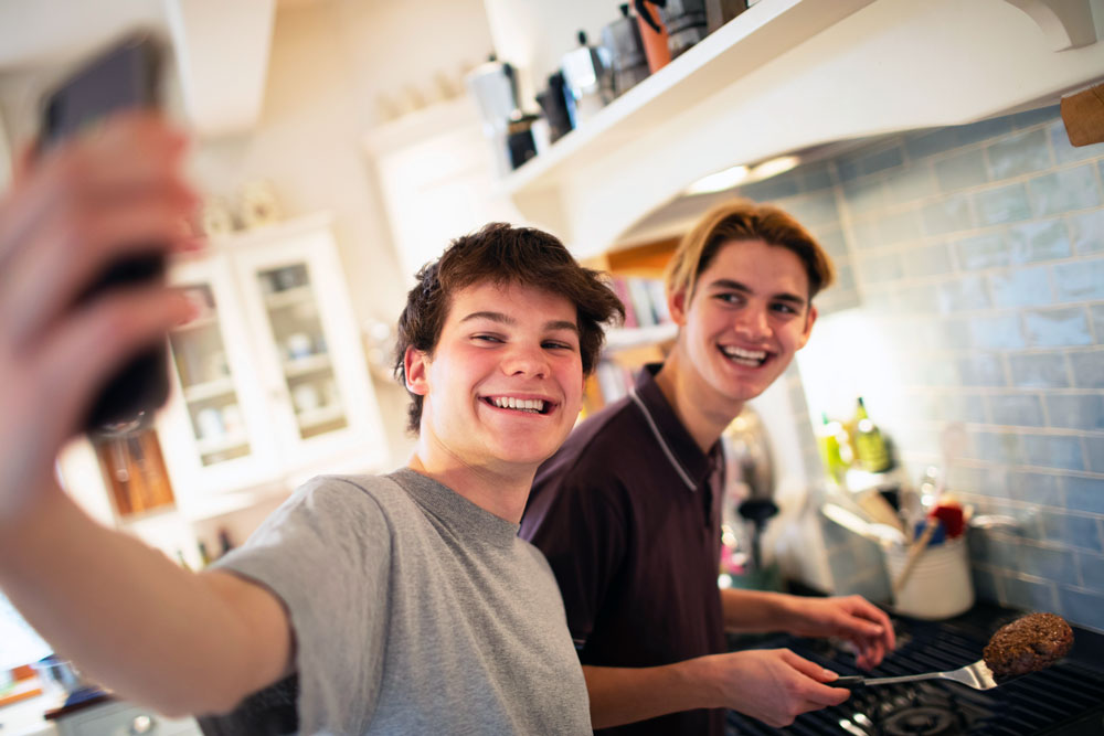 Two teen boys taking a selfie.
