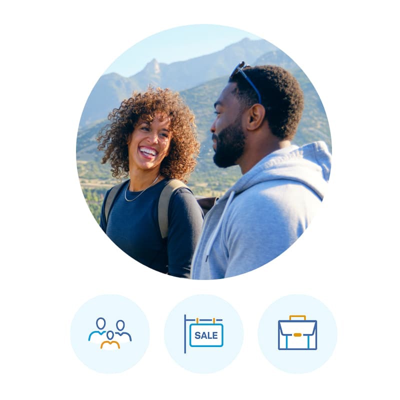 A circular photo of a couple hiking together, smiling and talking. Below the photo are three icons: a family symbol, a calendar with “SALE” on it, and a briefcase.