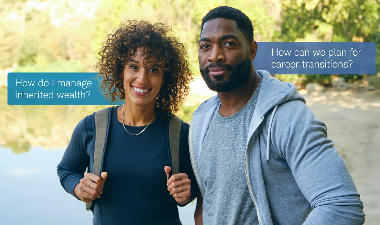 A couple standing outdoors near a lake, smiling at the camera. Speech bubbles beside them read: “How do I manage inherited wealth?” and “How can we plan for career transitions?”  