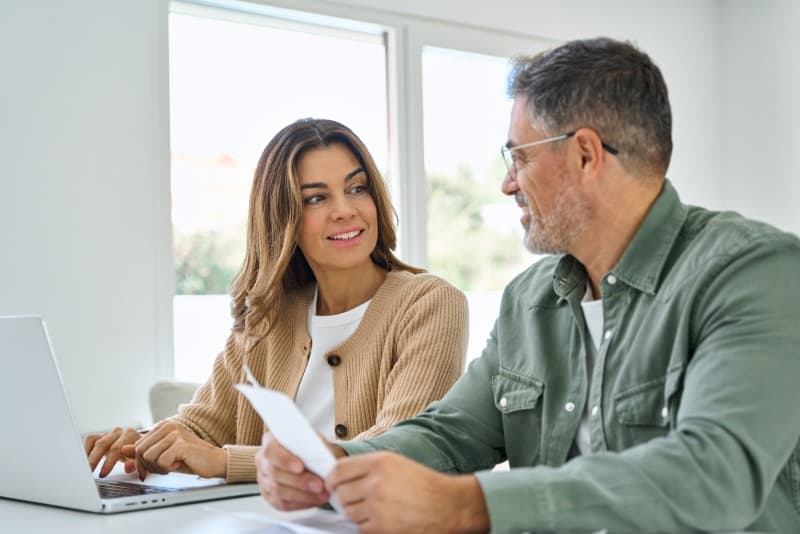 A couple, Diya and Ravi, discuss some paperwork.