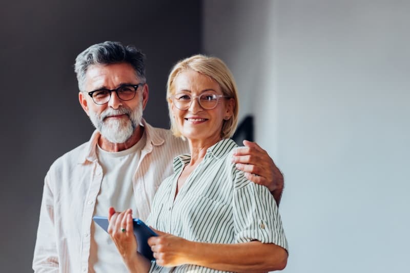 A couple, Gillian and Jack, smile at the camera.