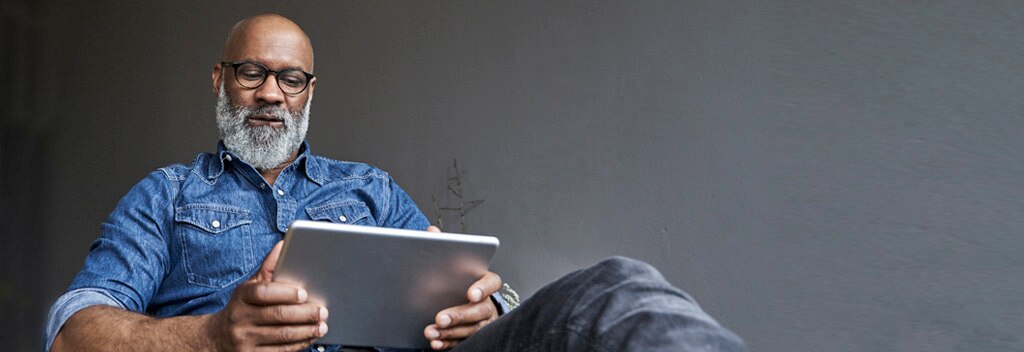 Man seated with a tablet