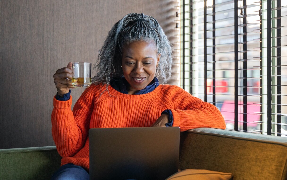 Investor using laptop and drinking tea