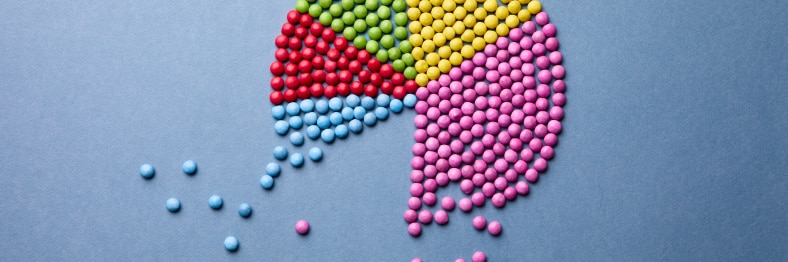 Photo of colorful marbles arranged in the shape of a pie chart.