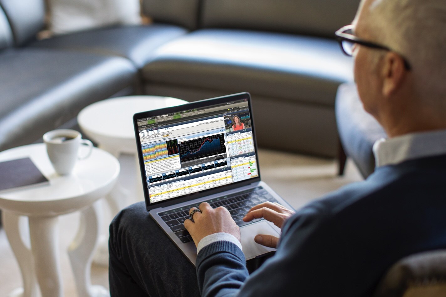 Male options trader using StreetSmart edge on laptop