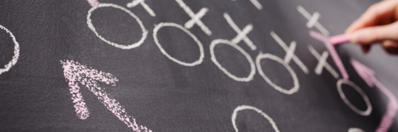 Photo of a chalkboard with a football play diagram.