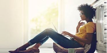 Woman looking at a laptop.