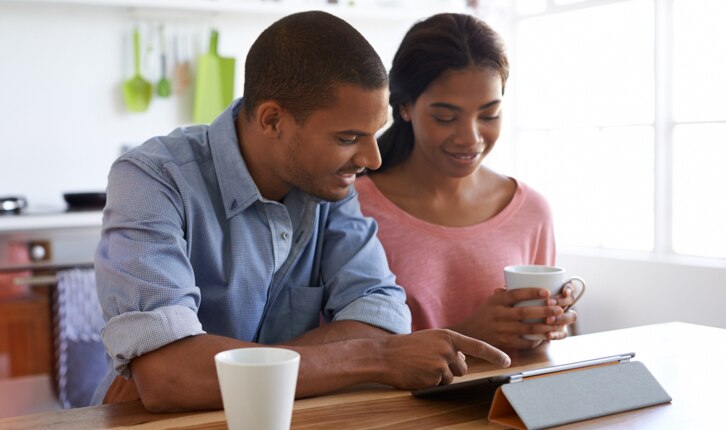 Two people looking at a tablet