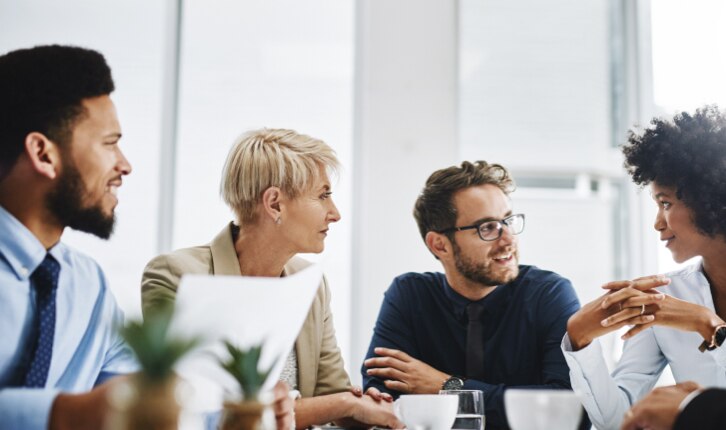 A group of four people talking