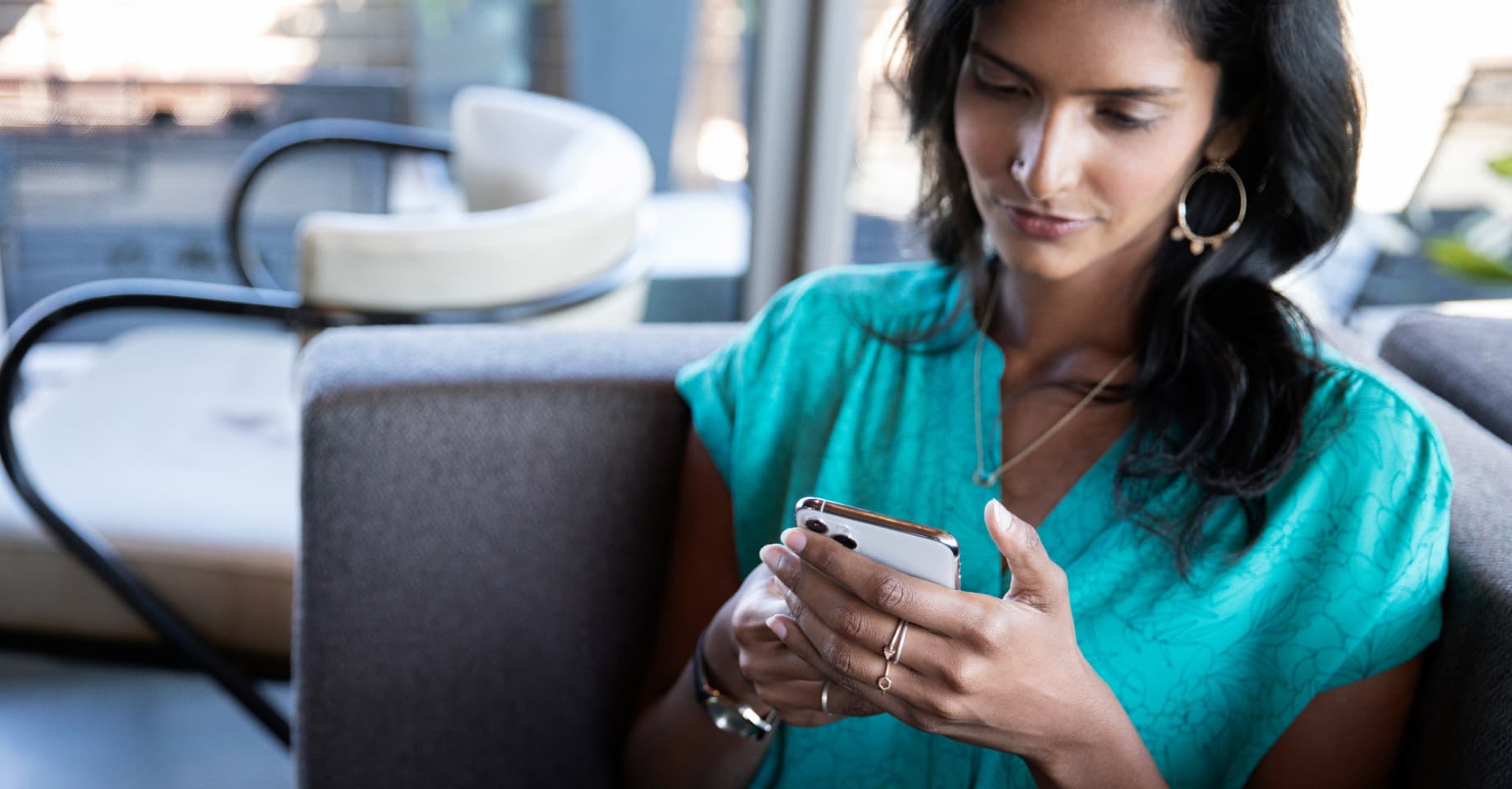 A woman in green on her phone. 
