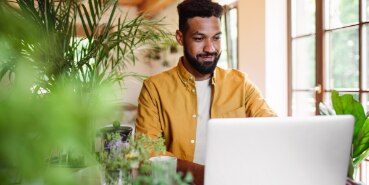 Man looking at laptop screen and smiling