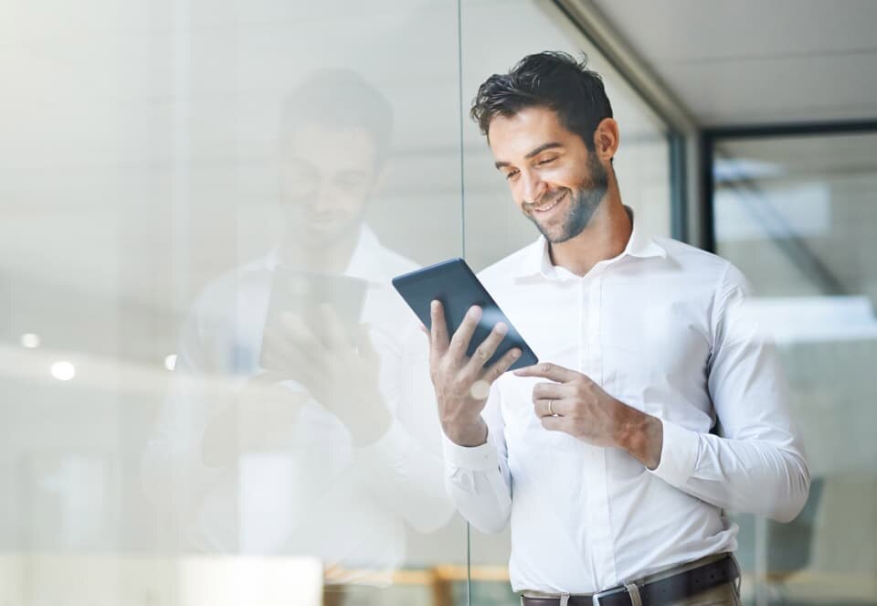 Man looking at Schwab Intelligent Portfolios on tablet