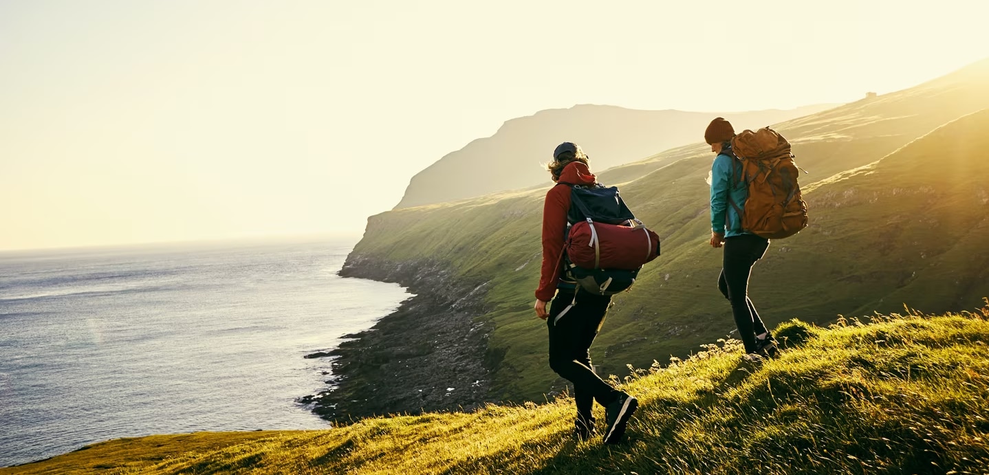 People walking along the coast.